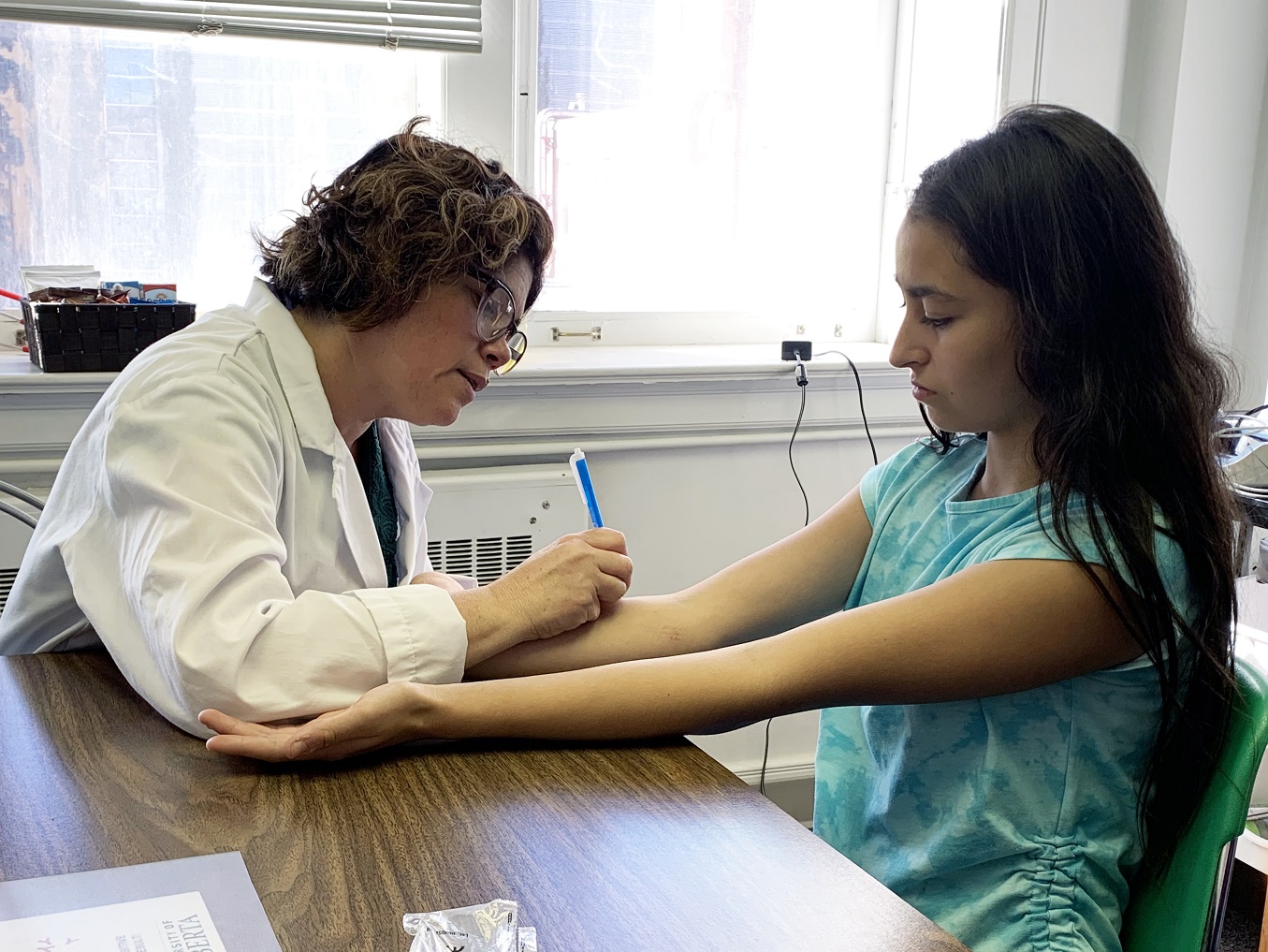 Edmonton: Research Assistant Fabiana conducts a skin prick test on Lila