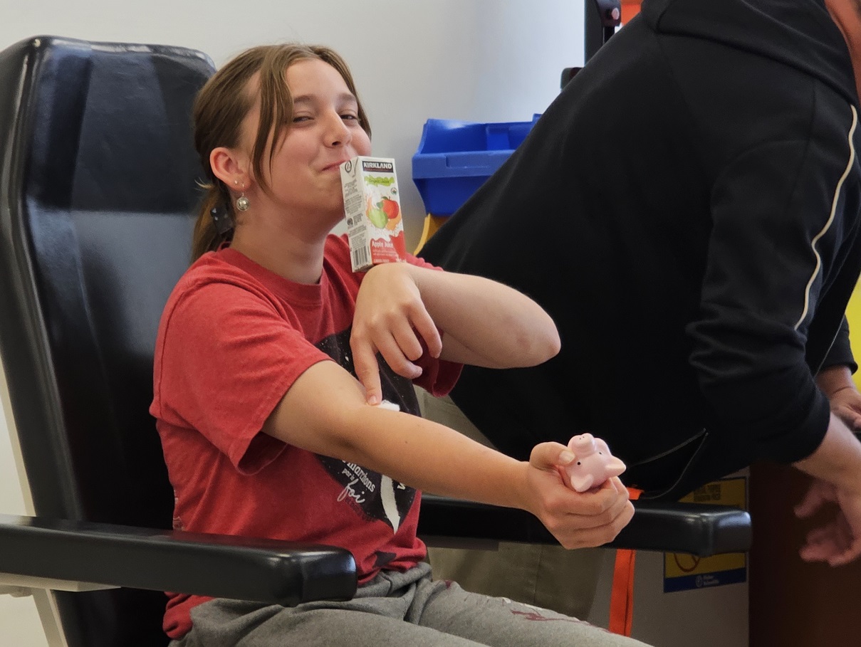 Manitoba: A brave Study participant smiles after giving a blood sample