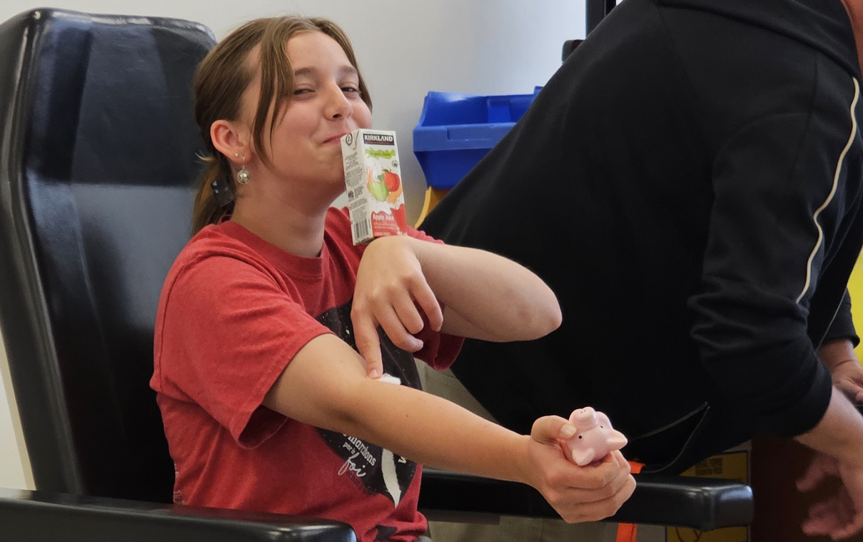 Manitoba: A brave Study participant smiles after giving a blood sample